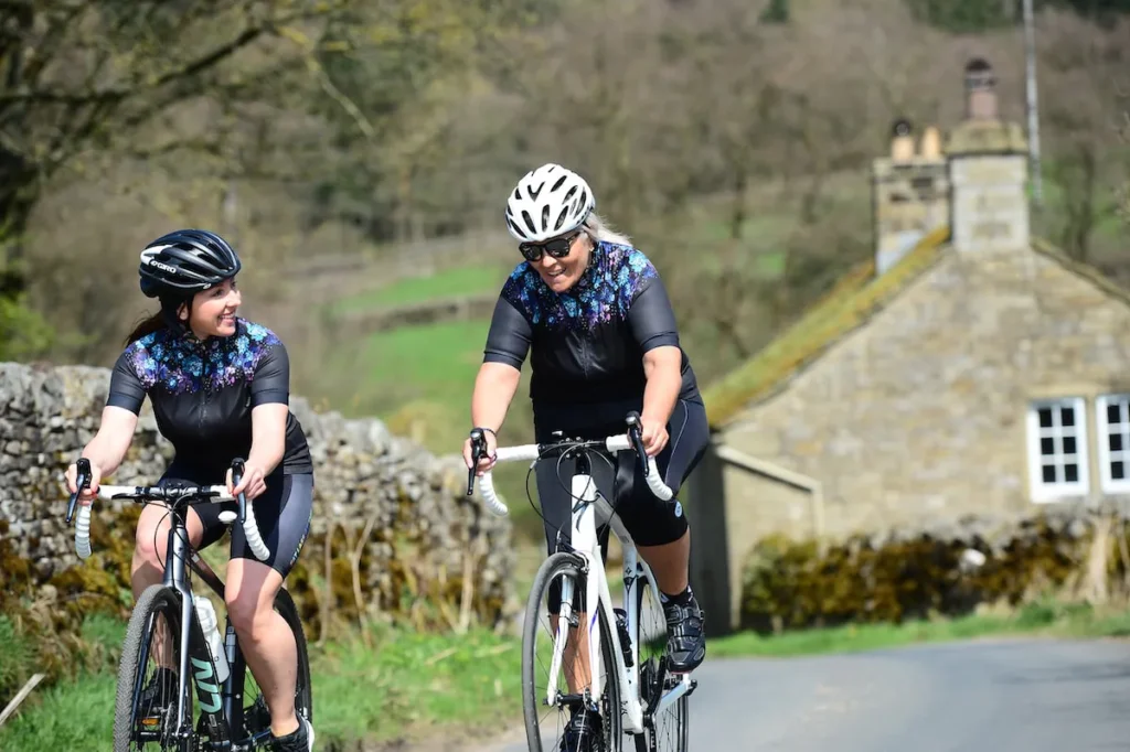 Two riders with dark cycling glasses lenses