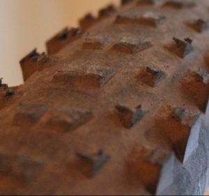 A mountain bike tire whose tread shows it needs to be replaced