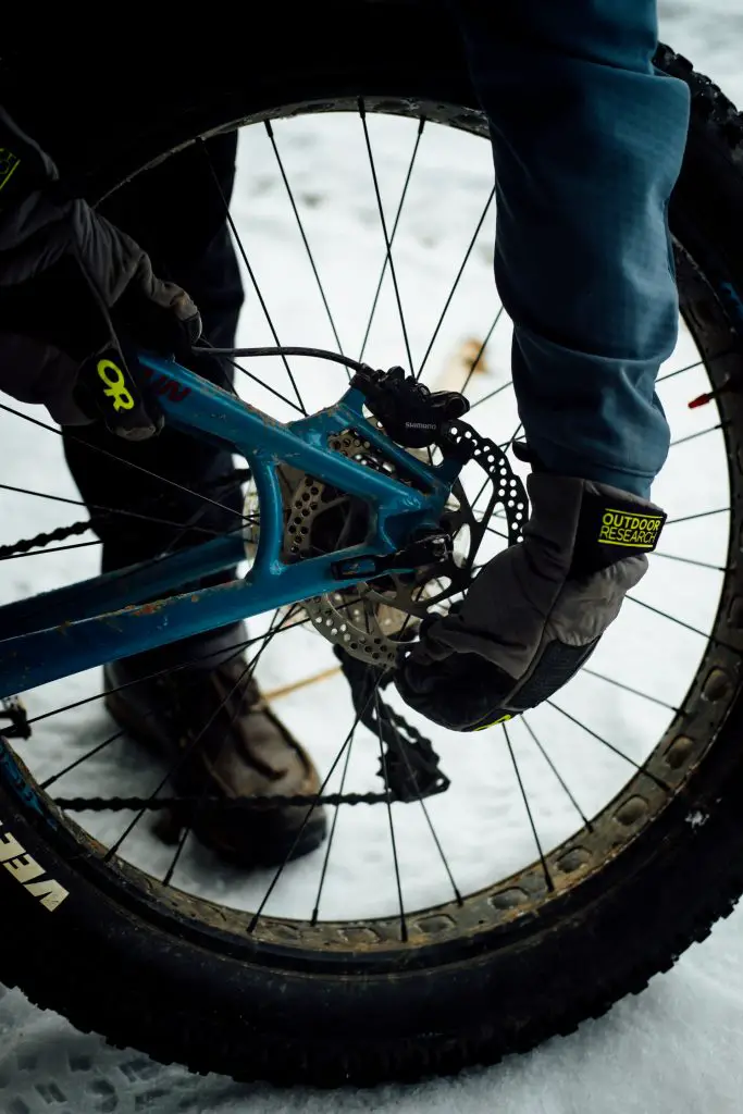 The rear tire and brakes on a fat bike