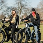 two people riding fat bikes in the park