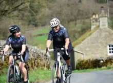 Two riders with dark cycling glasses lenses